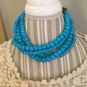 Blue beaded necklace with wooden fastener